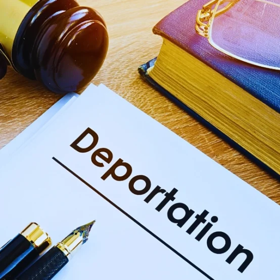 Deportation and other documents on a desk. Waivers Can Help You Avoid Deportation